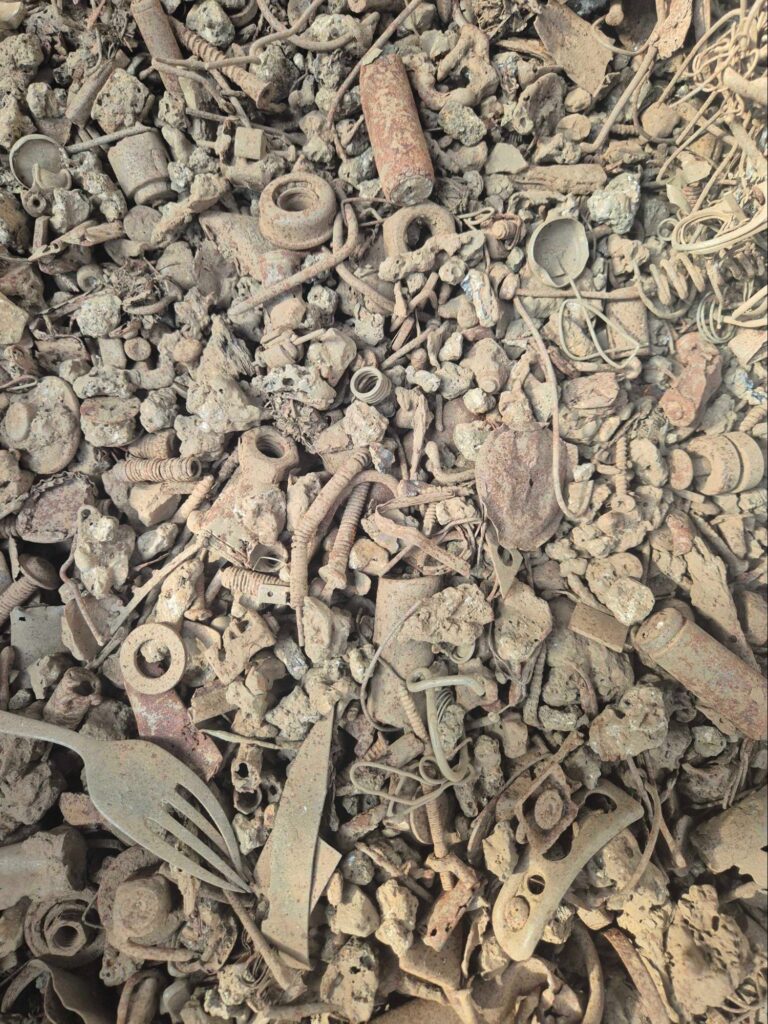 Non-ferrous fraction recovered from incinerator bottom ash: mixed metal pieces coated in ash